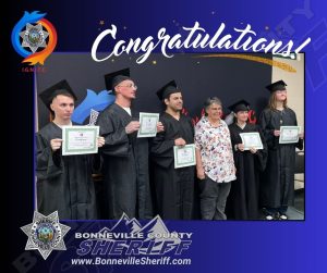 Six people in graduation gowns hold certificates and pose for a photo with a woman in casual clothes. "Congratulations" is written above. The Bonneville County Sheriff’s Office logo and website appear at the bottom.