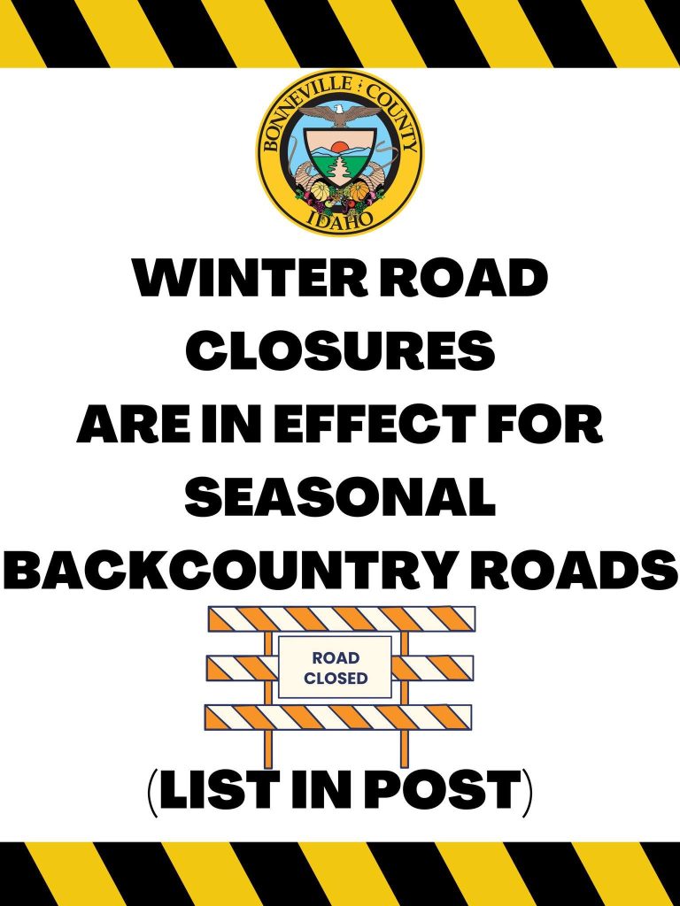 Notice with Bonneville County, Idaho seal, reads: "Winter road closures are in effect for seasonal backcountry roads (list in post)" with a "road closed" barricade illustration; yellow-black striped border.