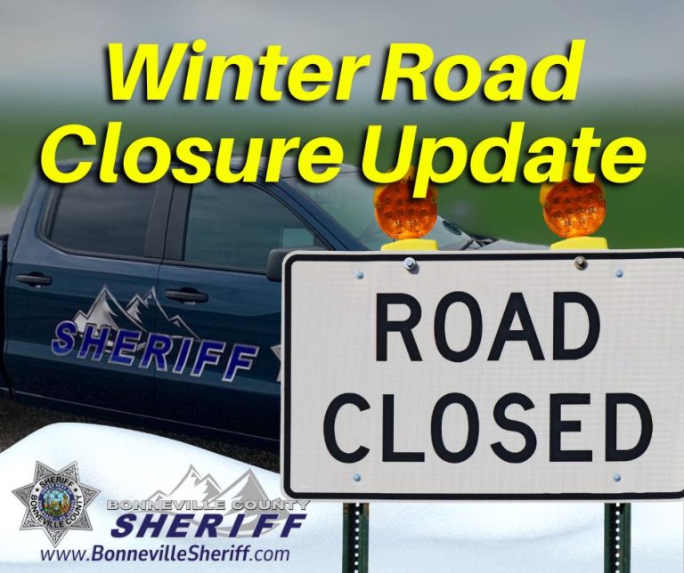 A sheriff's vehicle is parked next to a "ROAD CLOSED" sign with orange lights. Bold yellow text reads "Winter Road Closure Update." The Bonneville County Sheriff logo and website are at the bottom.